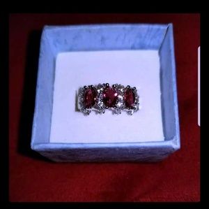 Silver and Rubies flanked by white sapphires